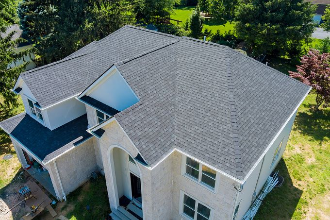 Aerial view of residential home with charcoal colored asphalt shingles
